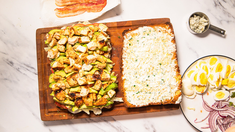 Layering focaccia with diced chicken