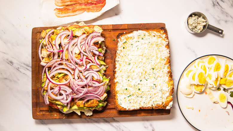 Layering focaccia with onion