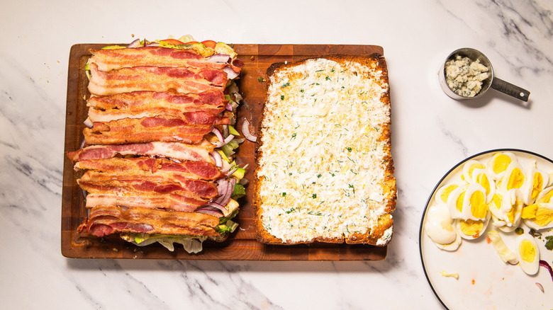 Layering focaccia with bacon