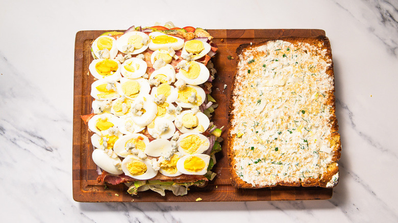 Layering focaccia with egg and blue cheese