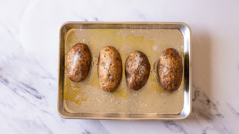 Baked potatoes on tray.