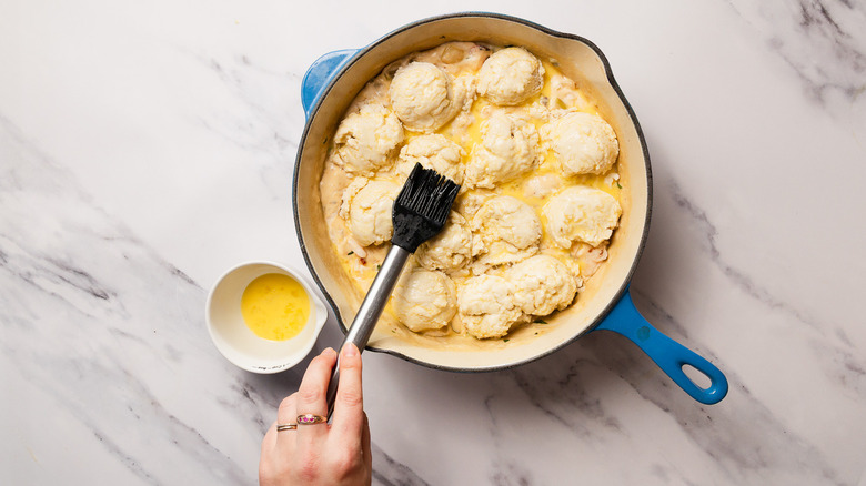 Brushing biscuits with egg