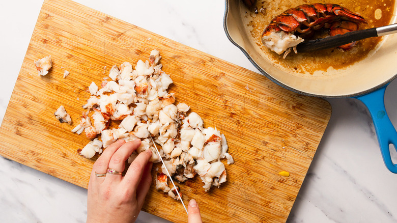 Dicing lobster meat on cutting board