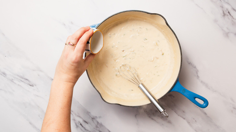 Adding lemon juice to thickened roux in pan