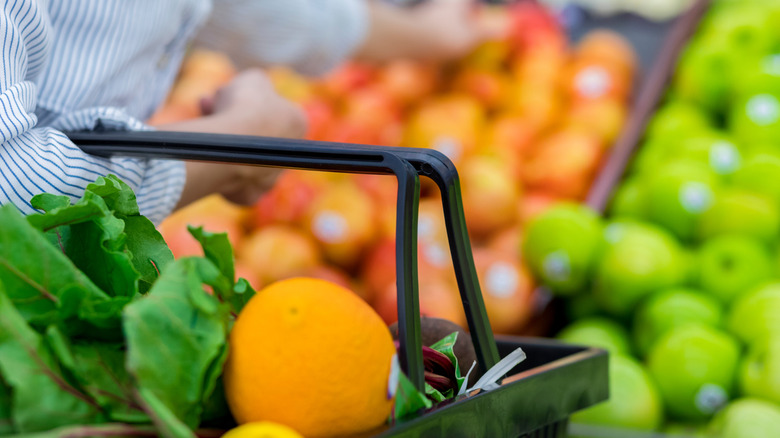 someone shopping for produce in grocery store