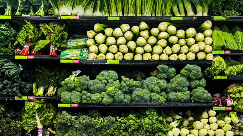 Green vegetables on shelves with local tag