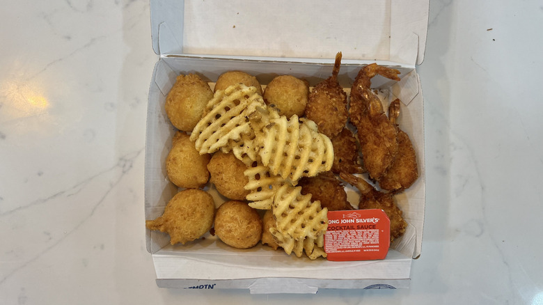 coconut shrimp meal with hush puppies and french fries