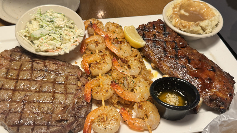 steaks and shrimp skewers on a plate