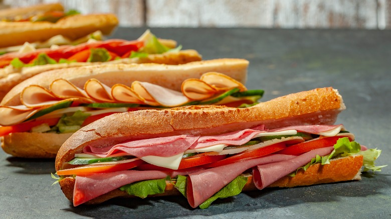 Row of packed sandwiches in baguettes