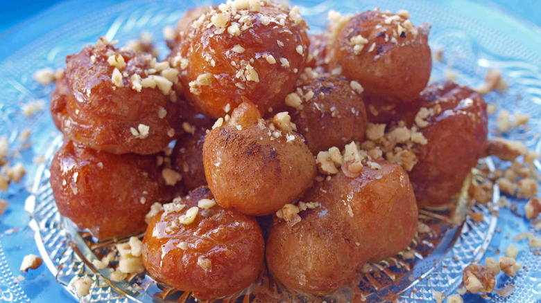 Loukoumades topped with chopped walnuts