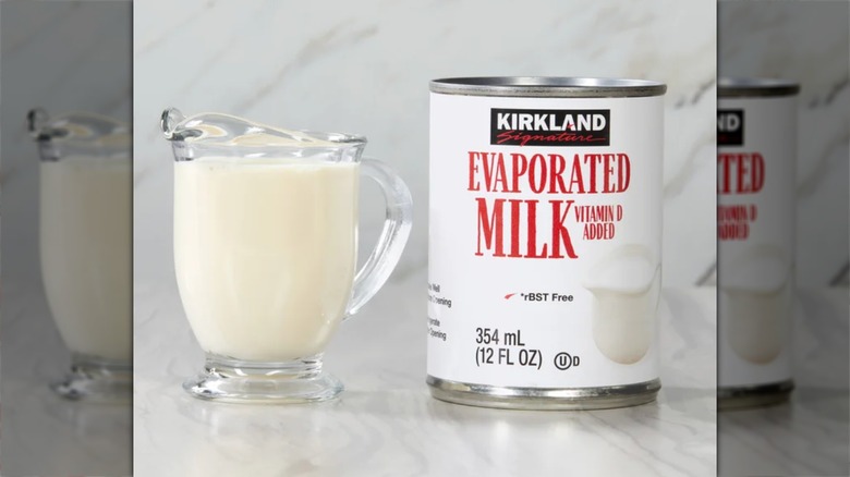 Kirkland Evaporated Milk next to a cup
