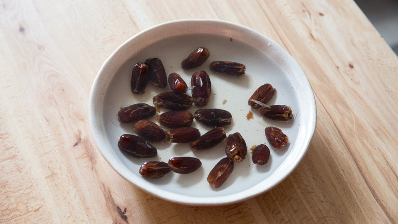 dates soaking in beige bowl