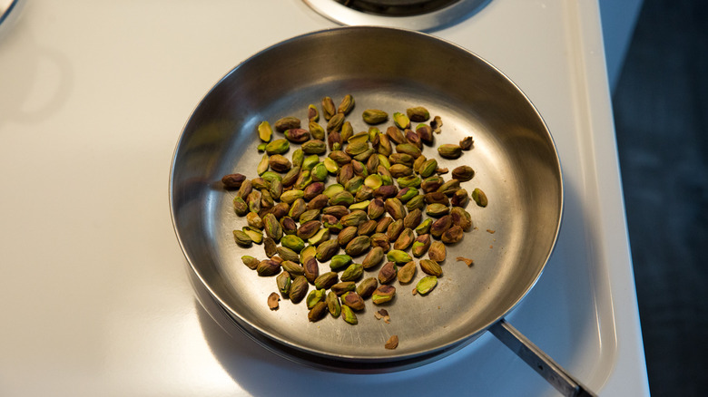 toasted pistachios in stovetop pan