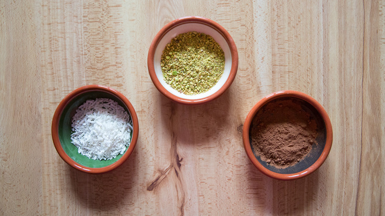 assorted toppings in terracotta bowls