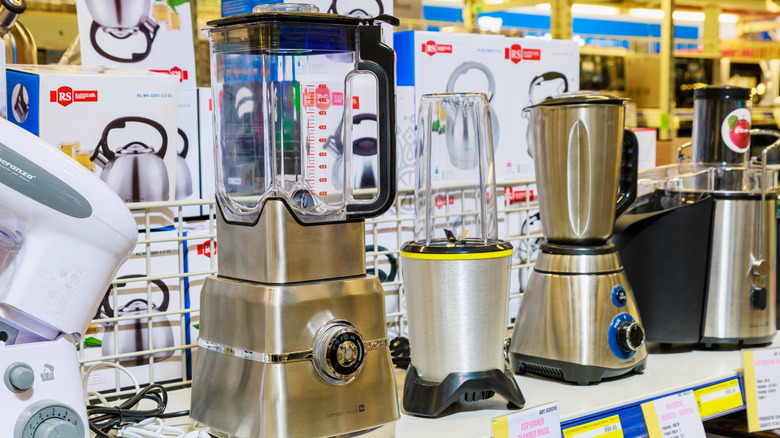 Various blenders and other kitchen appliances on a store shelf