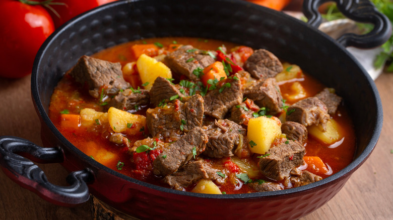 Beef goulash in a red and black dish