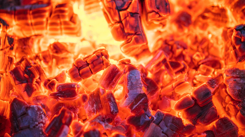 Burning orange charcoal pieces grill