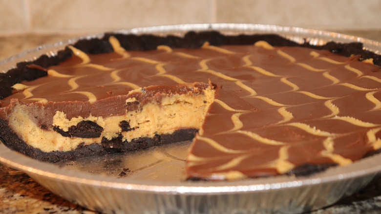 Closeup of peanut butter pie with Oreo cookie crust and topped with chocolate