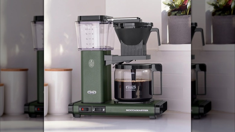 Technivorm Moccamaster KBGV Select on a kitchen counter next to a potted plant