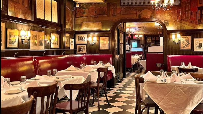 A sign dominates the main street entrance for Minetta Tavern Restaurant in New York