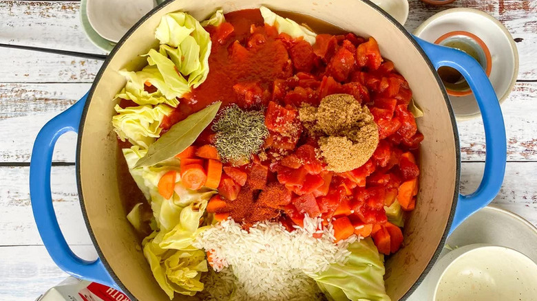 Preparing cabbage roll soup in blue bowl