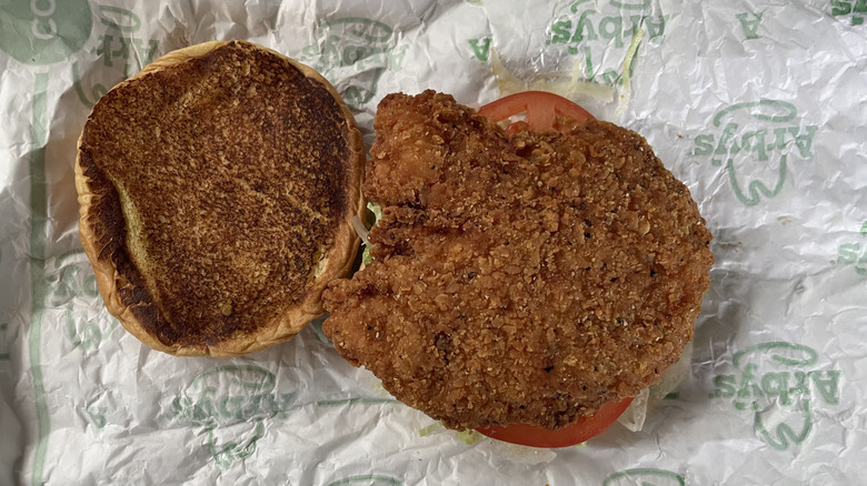 Arby's fried chicken sandwich on paper wrapping