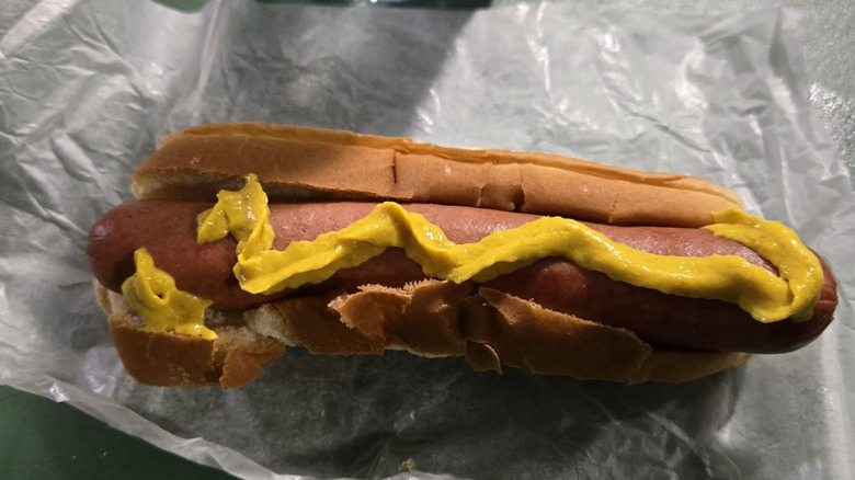 Fenway Frank with yellow mustard on white wrapper