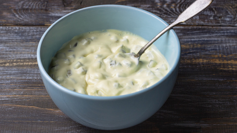 Bowl of homemade tartar sauce with a spoon in it