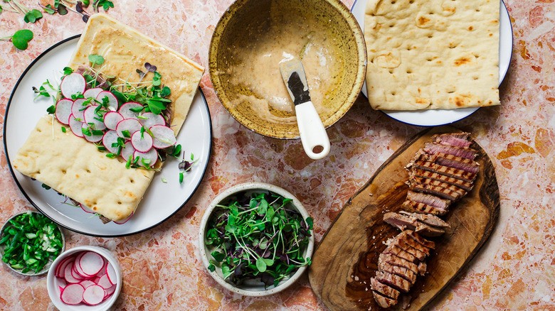 Topping tuna sandwiches with the rest of the ingredients