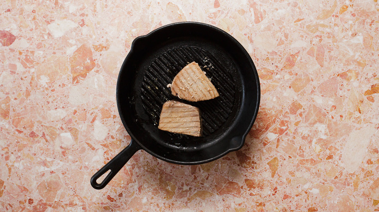 Tuna steaks cooking in pan