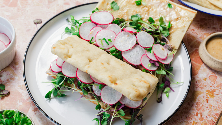 Two ahi tuna sandwiches on plate, one of them open