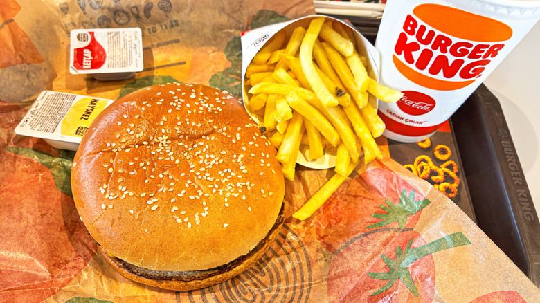 A Burger King meal with burgers a fries is on a tray.