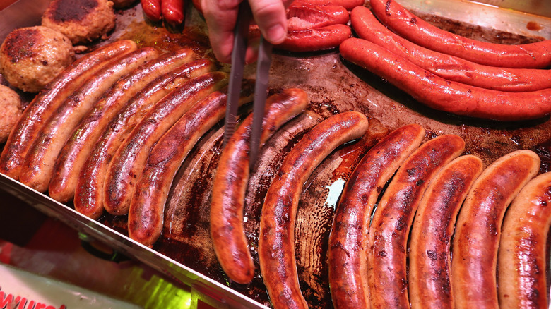 A grill full of German bratwurst