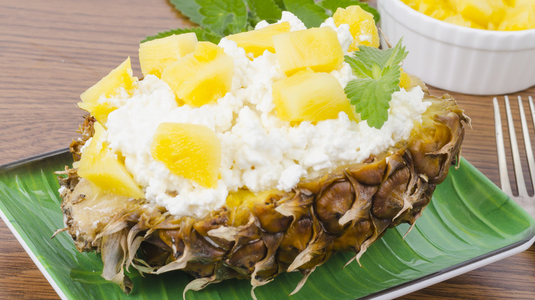 Cottage cheese and pineapple chunks in pineapple shell.