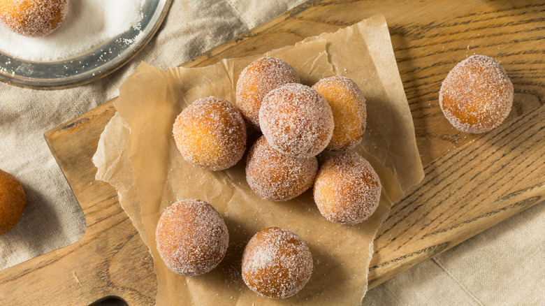 Top-down view of donut holes with cinnamon sugar coating