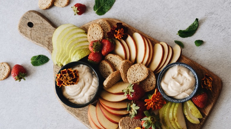 A platter of fruit with dip
