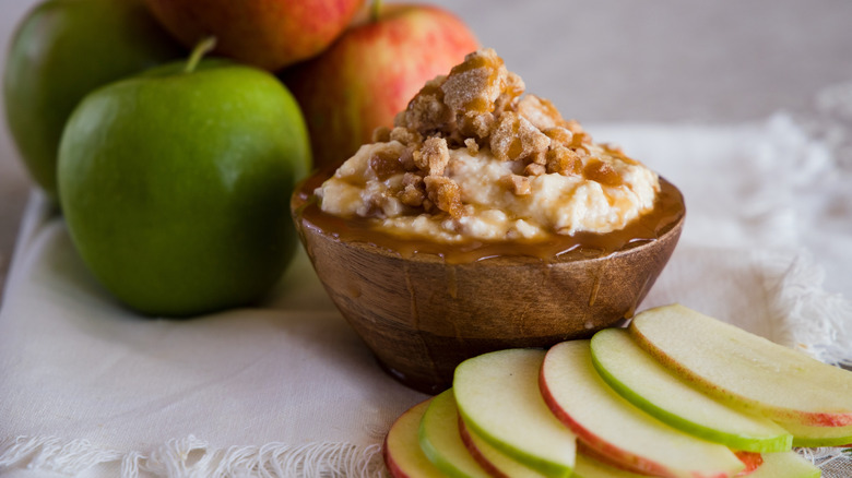 Fruit dip with sliced apples topped with caramel and crumble