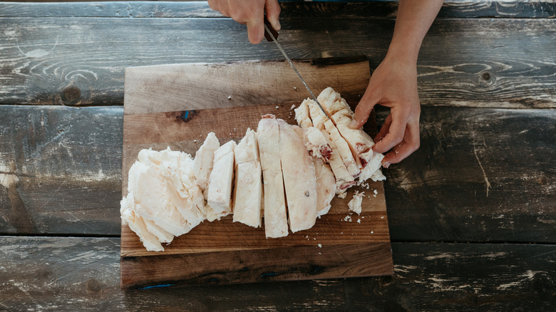 A person cuts raw suet