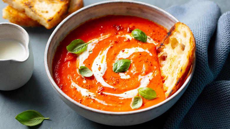 Homemade tomato soup garnished with cream drizzle