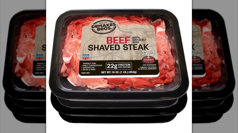 Two black packages of Demakes Bros. Choice Beef Shaved Steak stacked on top of one another