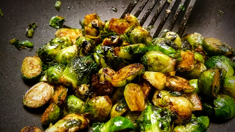 Balsamic glazed Brussels sprouts in pan with spatula