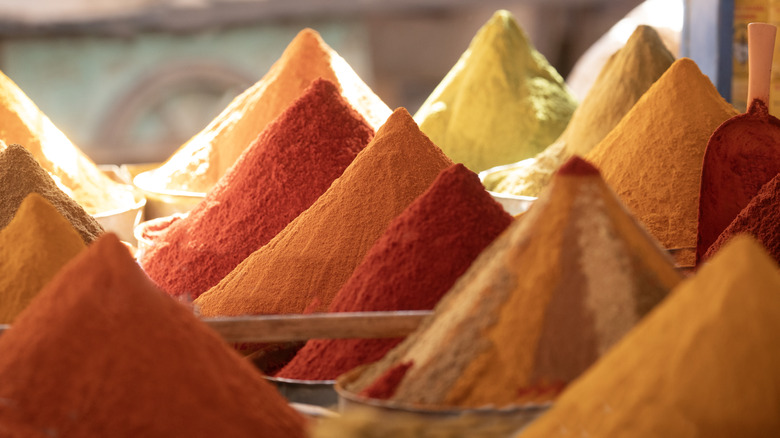 Pyramids of Moroccan spices on display at a market.