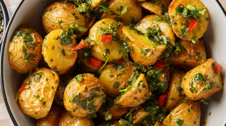 Crispy roasted potatoes in a bowl with herbs