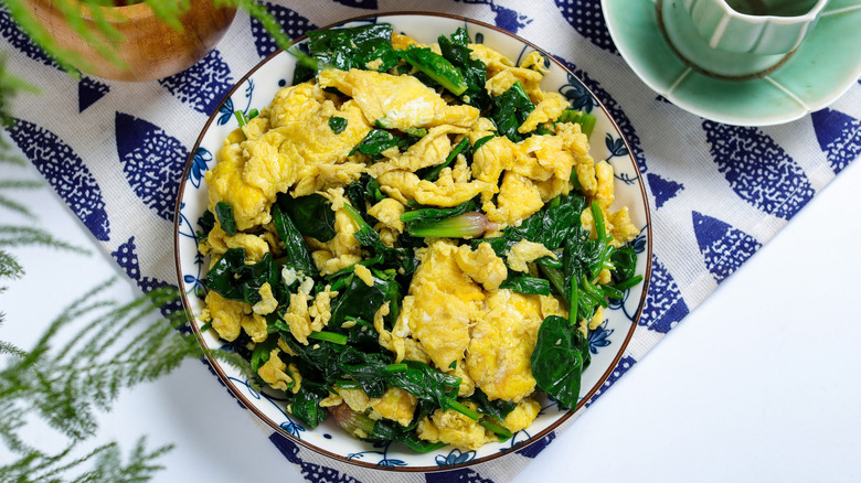 A bowl of scrambled eggs with spinach