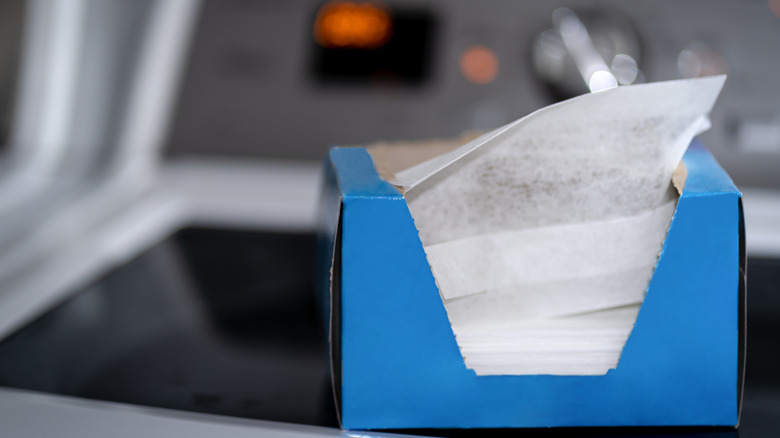 A box of dryer sheets on top of a washing machine