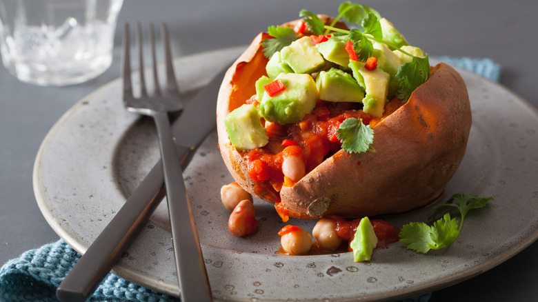 Sweet potato topped with chili on plate