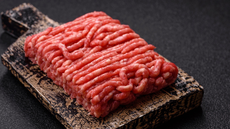 Raw ground beef on wooden board