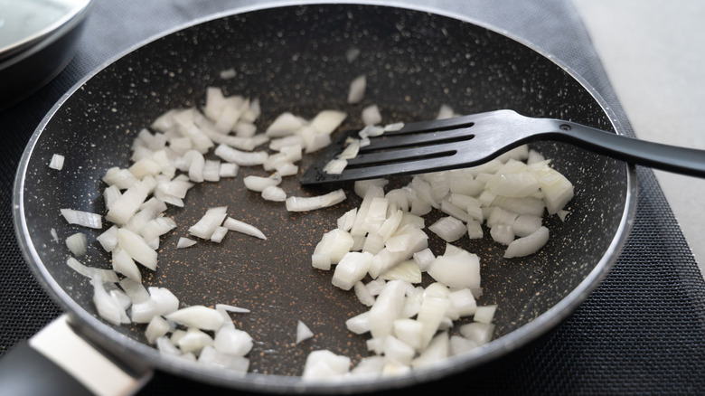 Diced onions sauteing in pan