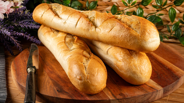 Baguettes on wooden cutting board