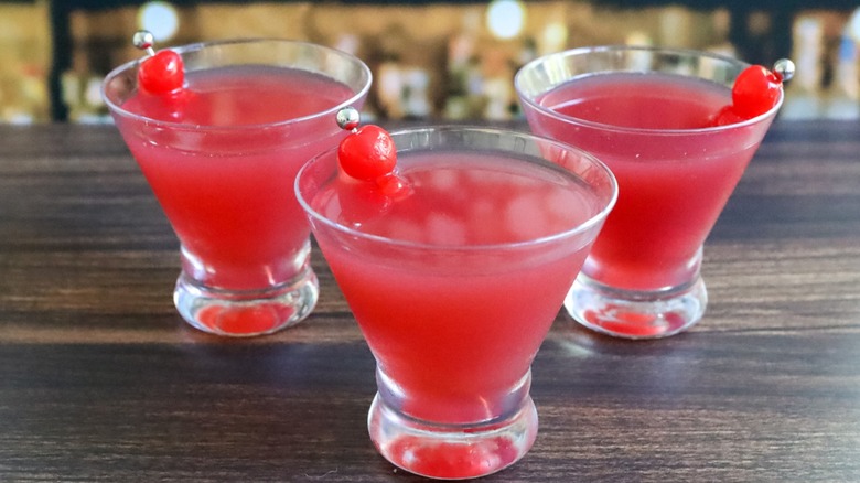 Three pink cocktails on bar